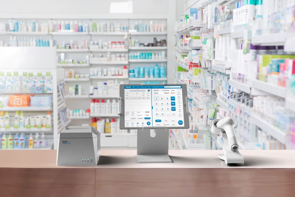 A pharmacy check-in station with Star Micronics printer, kiosk stand, and barcode scanner