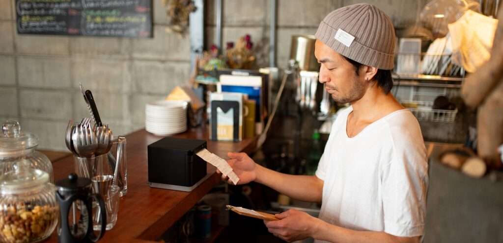 Man printing from mC-Print3 thermal receipt printer by Star Micronics.