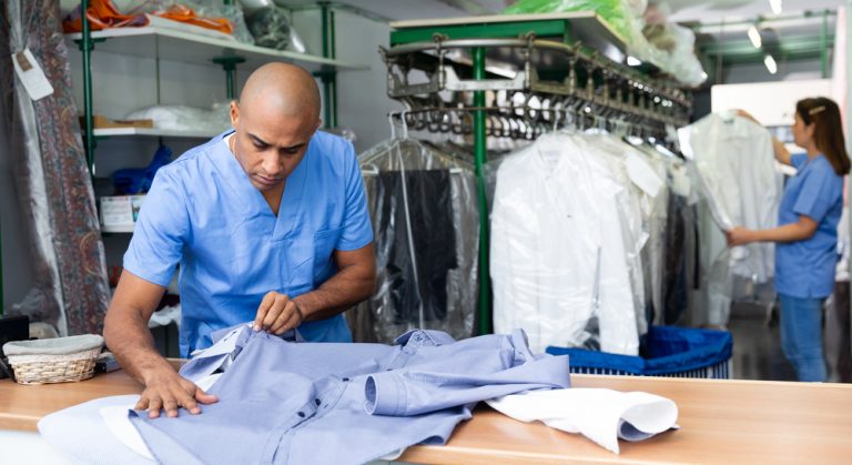 Man working in laundry business doing wash-and-fold service.