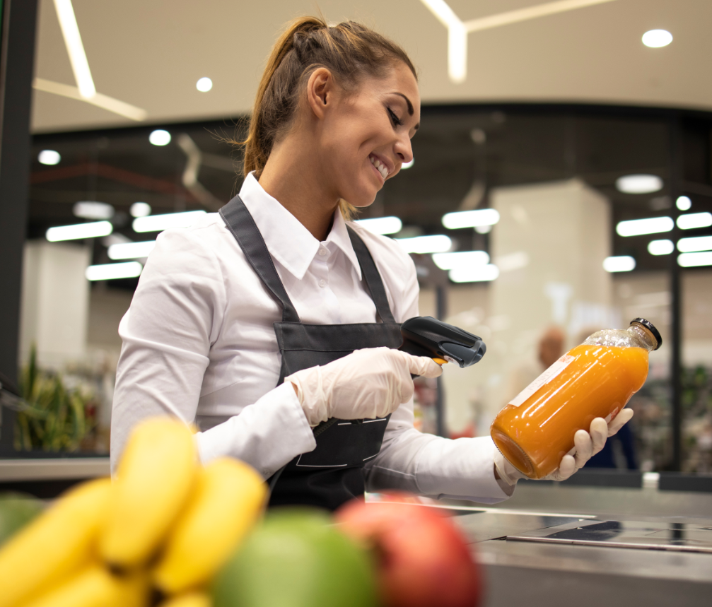Woman ringing up groceries with wireless barcode scanner by Star Micronics.